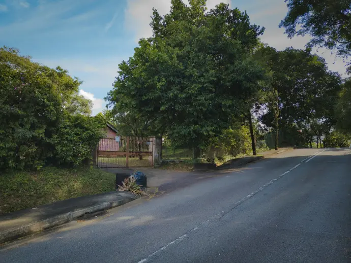 an empty street with a bench on the side of it